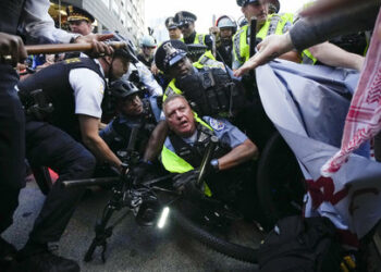 Demonstrators clash with police near the Israeli Consulate during the Democratic National Convention Tuesday, Aug. 20, 2024, in Chicago. (AP Photo/Julio Cortez)