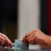 A voter casts their ballot, during the first round of the early French parliamentary elections at a polling station in Le Touquet-Paris-Plage, France, June 30, 2024. REUTERS/Yara Nardi