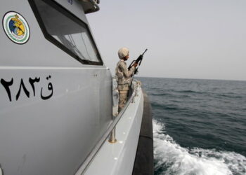 A Saudi border guard watches as he stands in a boat off the coast of the Red Sea on Saudi Arabia's maritime border with Yemen, near Jizan April 8, 2015. Iran sent two warships to the Gulf of Aden on Wednesday, state media reported, establishing a military presence off the coast of Yemen where Saudi Arabia is leading a bombing campaign to oust the Iran-allied Houthi movement. REUTERS/Faisal Al Nasser