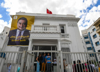 A poster of imprisoned presidential candidate Ayachi Zammel is displayed at the entrance of his electoral headquarters on September 16, 2024, in Tunis, ahead of presidential election. Tunisian presidential candidate Ayachi Zammel was placed in custody shortly after being released from pretrial detention on suspicion of forging ballot signatures, his lawyer said on Friday. Zammel, 43, is one of only two candidates approved by the electoral authority, ISIE, to challenge President Kais Saied in the October 6 poll. (Photo by FETHI BELAID / AFP)