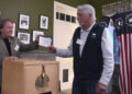 Town Moderator Tom Tillotson, left, accepts the first ballot from Les Otten during the midnight vote on Election Day, Tuesday, Nov. 5, 2024, in Dixville Notch, N.H. (AP Photo/Charles Krupa)