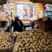 A vendor organizes his products besides a poster with an image of Egyptian President Abdel Fattah el-Sisi, at a vegetable market in Cairo, Egypt March 22, 2022. REUTERS/Mohamed Abd El Ghany