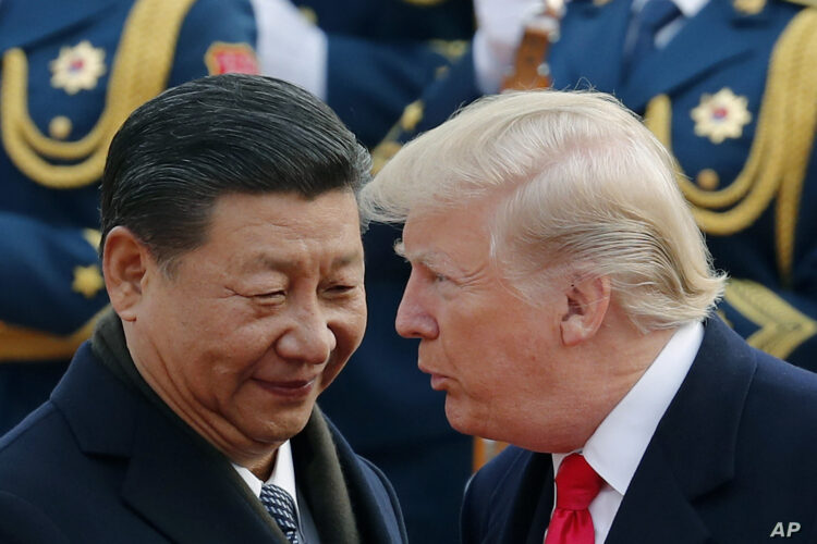 FILE - In this Nov. 9, 2017, file photo, U.S. President Donald Trump, right, chats with Chinese President Xi Jinping during a welcome ceremony at the Great Hall of the People in Beijing. Trump has shaken up Asia, as he has much of the world. Now Beijing, Seoul and other Asian capitals are waiting to see if the Democrats wrest control of at least one house of Congress from the Republicans - and whether that would significantly alter U.S. foreign policy and trade initiatives. For China, the hope is he might be forced to ease off on trade. The world’s two biggest economies have been throwing escalating import tariffs at each other since March, unnerving global markets. (AP Photo/Andy Wong, File)