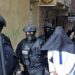 Members of Moroccos's Central Bureau of Judicial Investigation (BCIJ), which oversees counter-terrorism operations, escort a suspect outside a house in the city of Tangier, on October 6, 2021. (Photo by AFP)