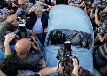 Uruguay's President Jose Mujica, center, leaves after casting his vote during general elections in Montevideo, Uruguay Sunday, Oct. 26, 2014. Uruguay’s presidential election is set to go into a runoff as undecided voters could opt for change on Sunday, despite an economic boom and social reforms led by the ruling Broad Front coalition. (AP Photo/Natacha Pisarenko)