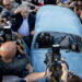 Uruguay's President Jose Mujica, center, leaves after casting his vote during general elections in Montevideo, Uruguay Sunday, Oct. 26, 2014. Uruguay’s presidential election is set to go into a runoff as undecided voters could opt for change on Sunday, despite an economic boom and social reforms led by the ruling Broad Front coalition. (AP Photo/Natacha Pisarenko)