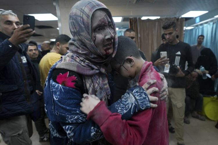 Palestinians wounded in the Israeli bombardment of the Gaza Strip are brought to the hospital in Deir al Balah on Friday, Dec. 8, 2023. (AP Photo/Adel Hana)