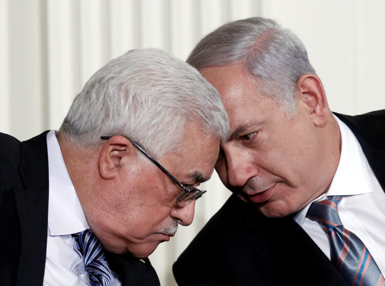FILE PHOTO: Israeli Prime Minister Benjamin Netanyahu (R) and Palestinian President Mahmoud Abbas speak during an event about the Middle East peace talks in the East Room at the White House in Washington September 1, 2010.   REUTERS/Jim Young   /File Photo