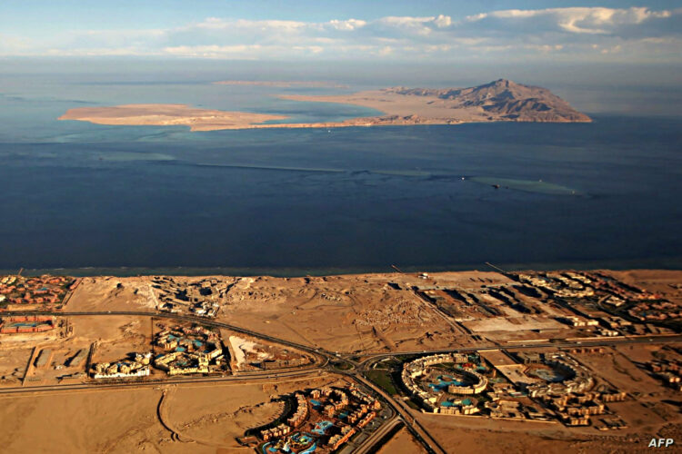 (FILES) This file photo taken on January 14, 2014 shows an aerial view of the Red Sea's Tiran (middle) and the Sanafir (background) islands in the Strait of Tiran between Egypt's Sinai Peninsula and Saudi Arabia at the mouth of the Gulf of Aqaba. - As US President Joe Biden visits the Middle East, one issue on the table will be the status of two the small Red Sea islands of Tiran and Sanfir that are uninhabited but of key strategic value. Resolving the tricky status that stems from their location and turbulent history would help build trust between Israel and Saudi Arabia, two US allies now taking gradual steps that Washington hopes could one day lead to diplomatic ties. (Photo by AFP)