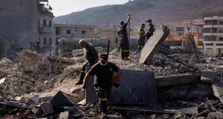 Rescue workers search for victims under the rubble of a building destroyed in an Israeli airstrike in the southern village of Kfar Rumman, Lebanon, Monday, Sept. 7, 2026. (AP Photo/Mohammed Zaatari)